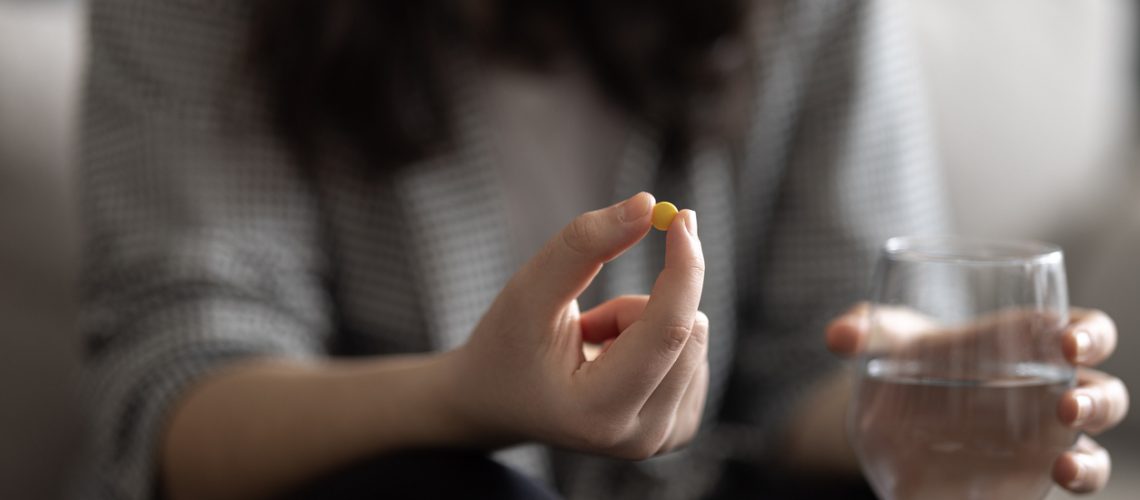 Woman medicating himself at home medicine