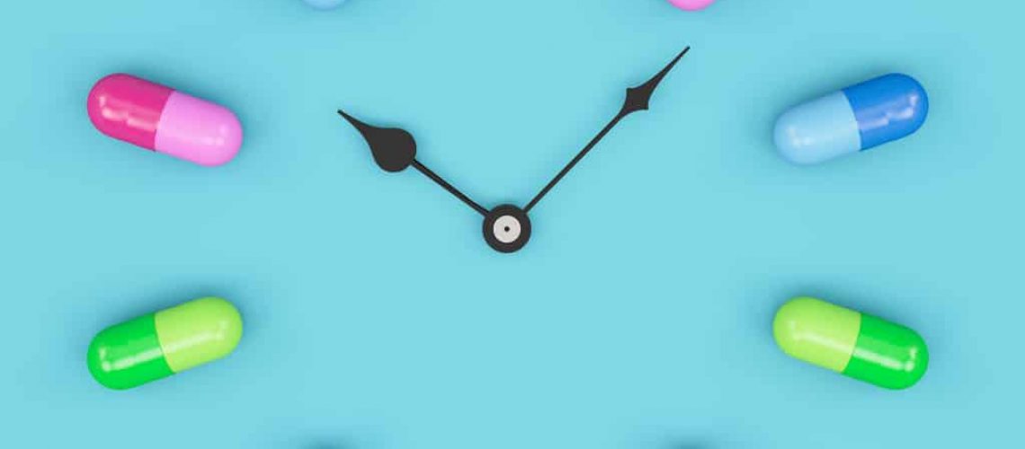 Time to Take a Pill Clock Face with Colorful Pills. 3D Render